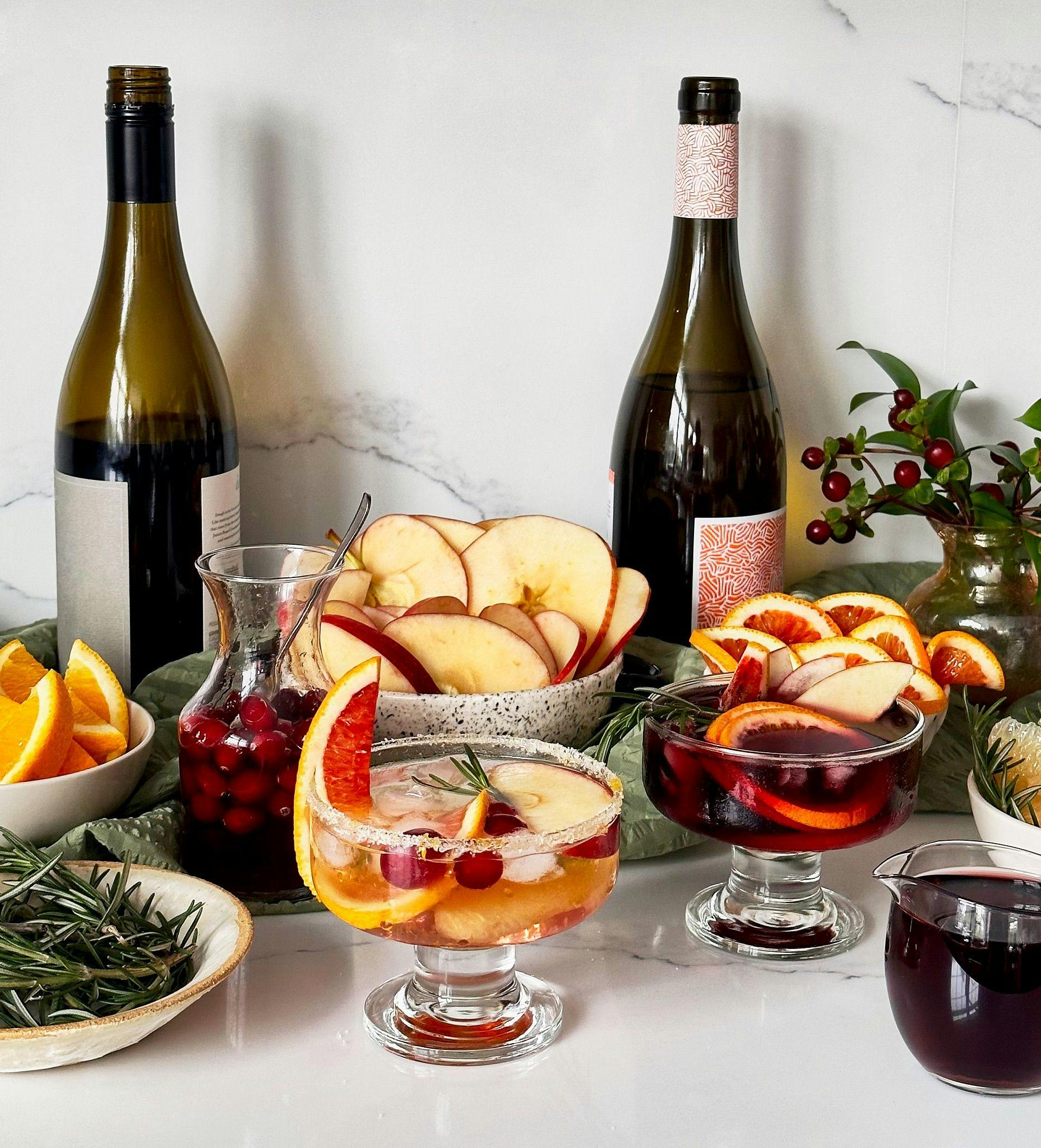 Winter seasonal sangria bar with apples, cranberry syrup, and oranges