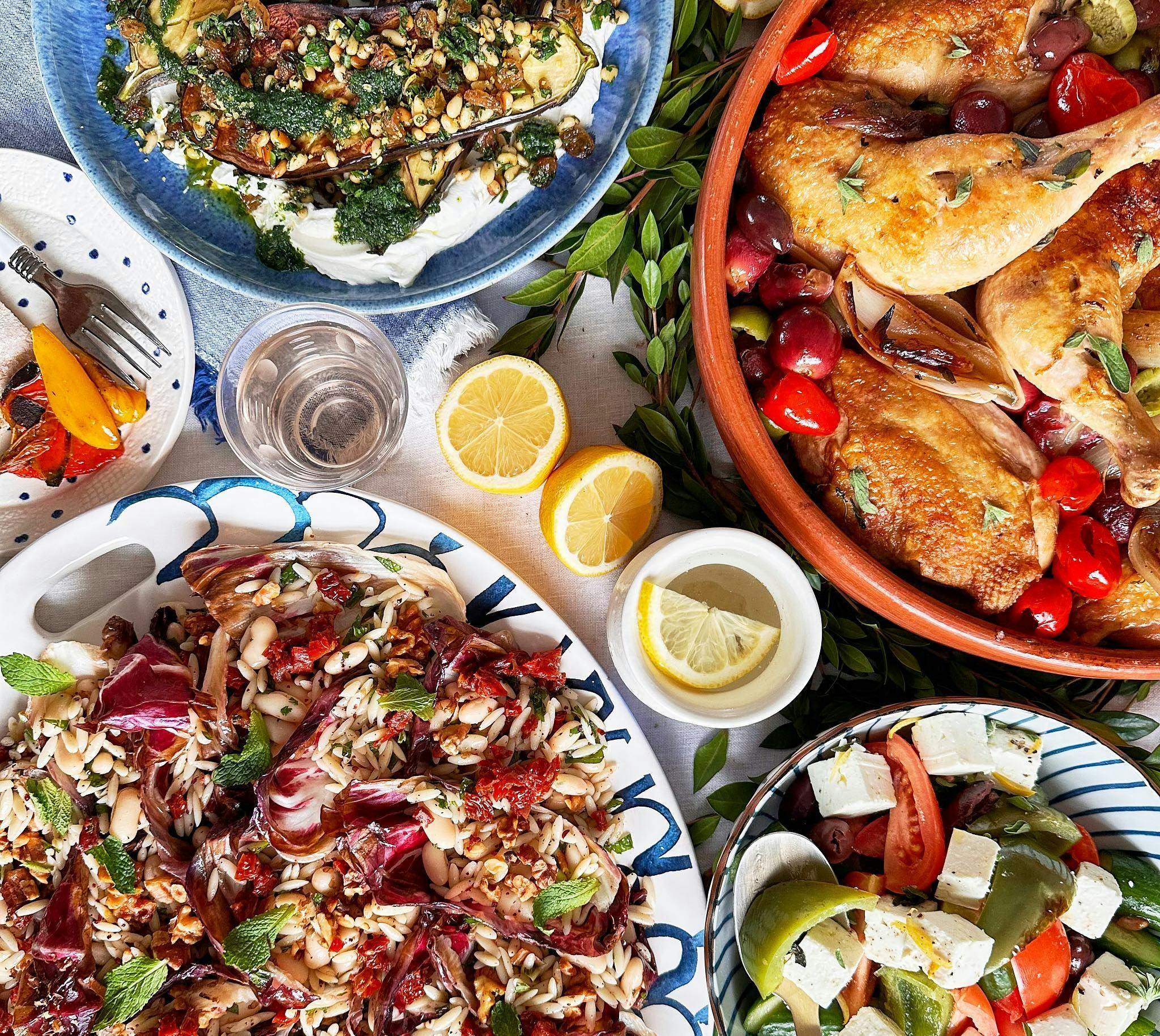Mediterranean spread with roast chicken, radicchio orzo salad, feta tomato salad, and charred eggplant with herbs