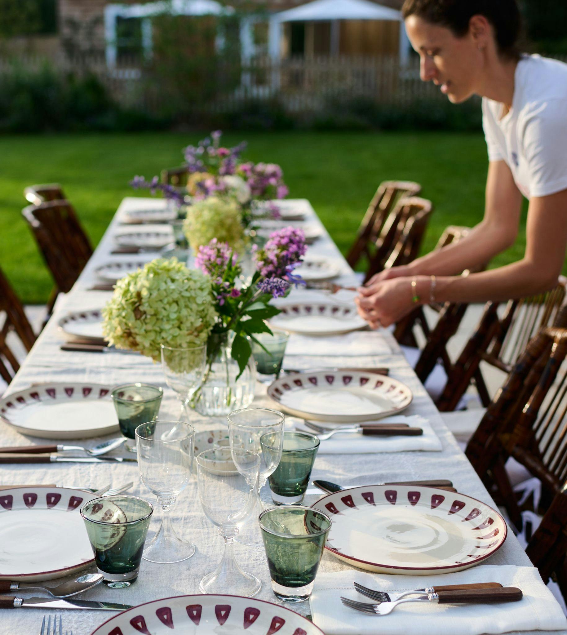 host setting a table outdoors