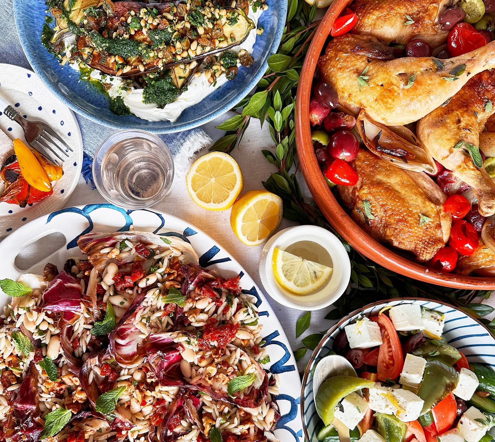 Mediterranean spread with roast chicken, radicchio orzo salad, feta tomato salad, and charred eggplant with herbs