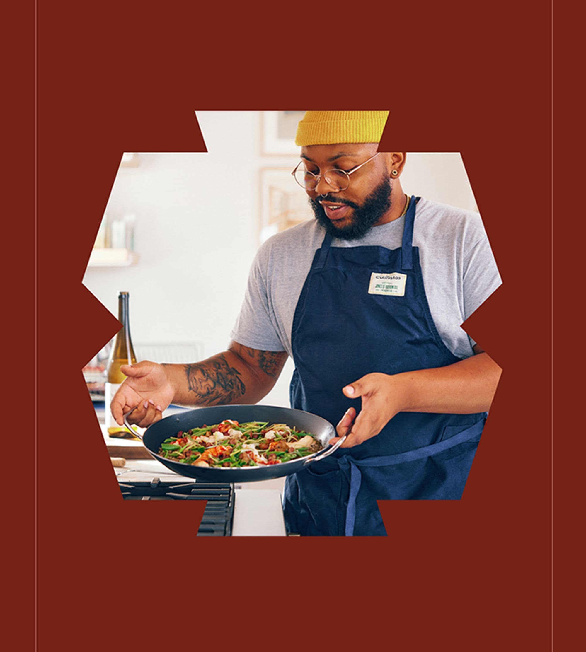 Chef holding lobster paella pan