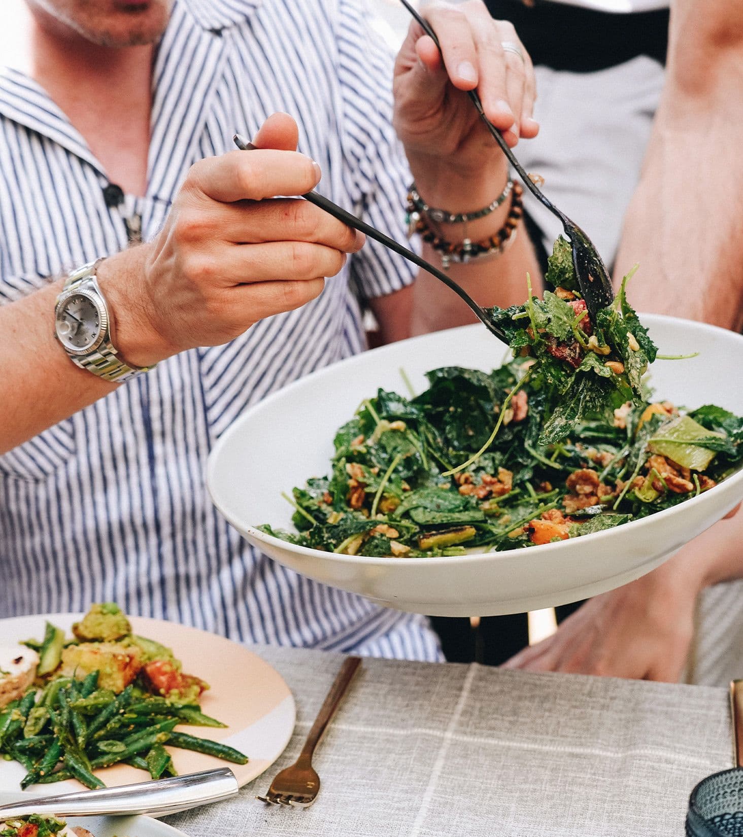 Person serving themselves salad