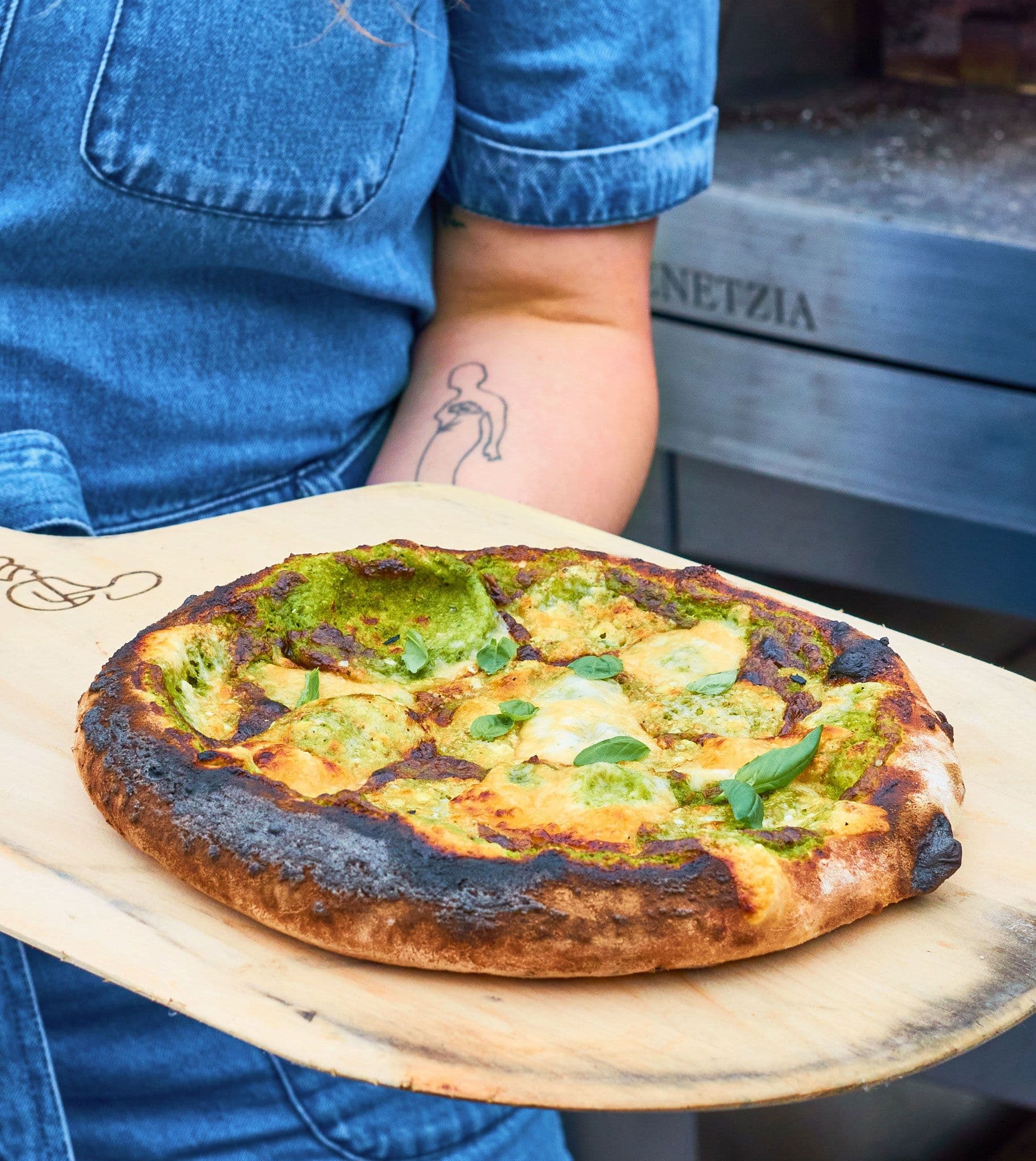 chef holding pizza