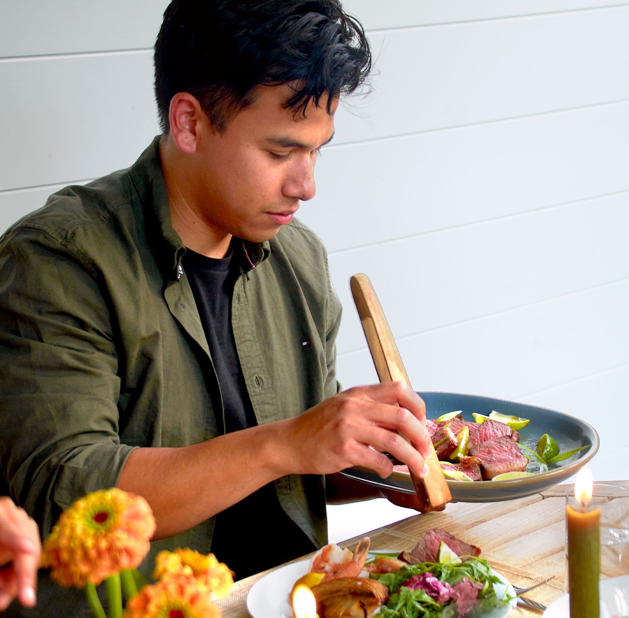 Man serving steak at table